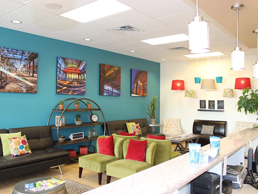 The Desert Ridge Dental front desk and waiting area with warm pendant lighting
