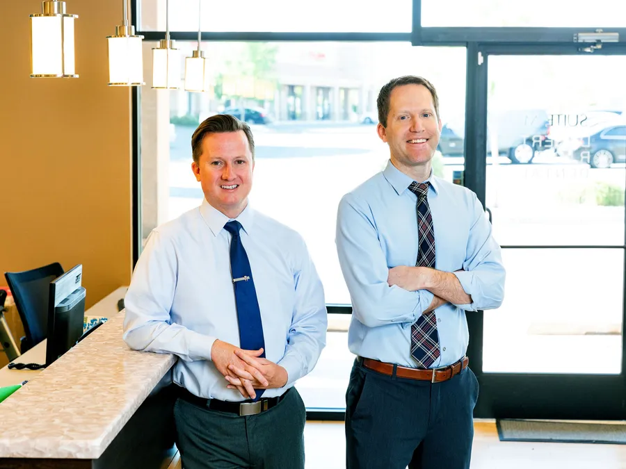 Dr. Rogers and Dr. Mink greeting patients at the Desert Ridge Dental front desk
