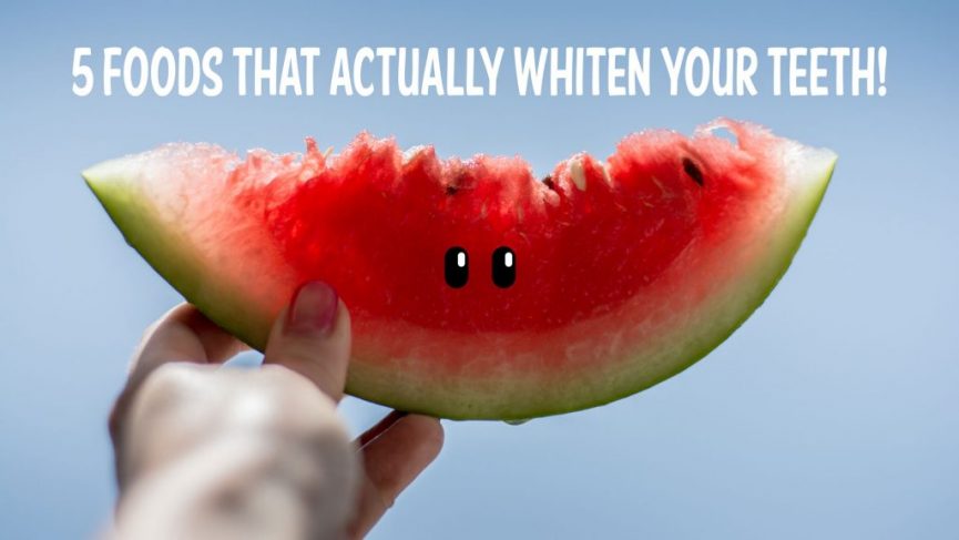 Person's hand holding a piece of watermelon