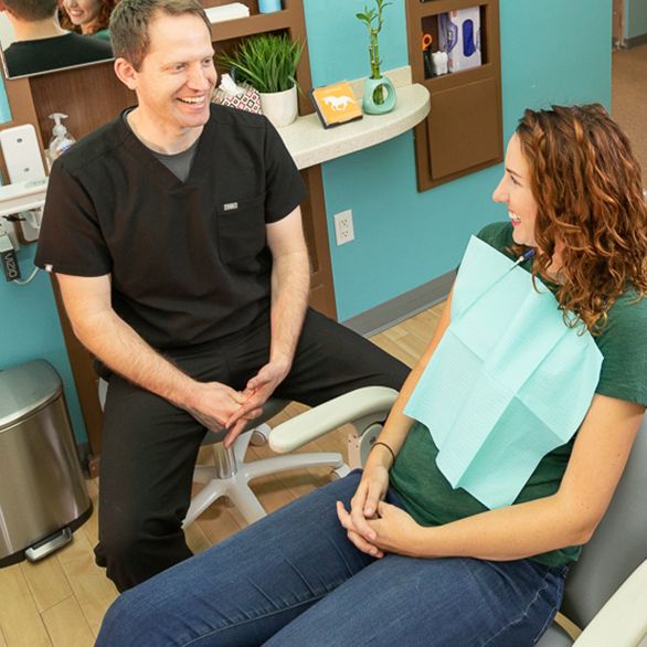 Dr. Mink speaking with dental patient.